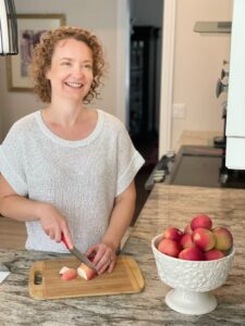 Anna Daniele Kazmierczak in the kitchen.  Eating healthy can be as simple as having cut up apples ready for snacking.