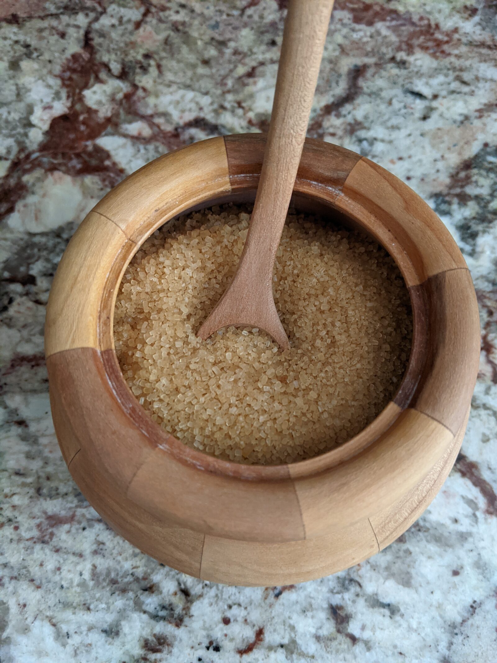 Raw sugar in wooden bowl